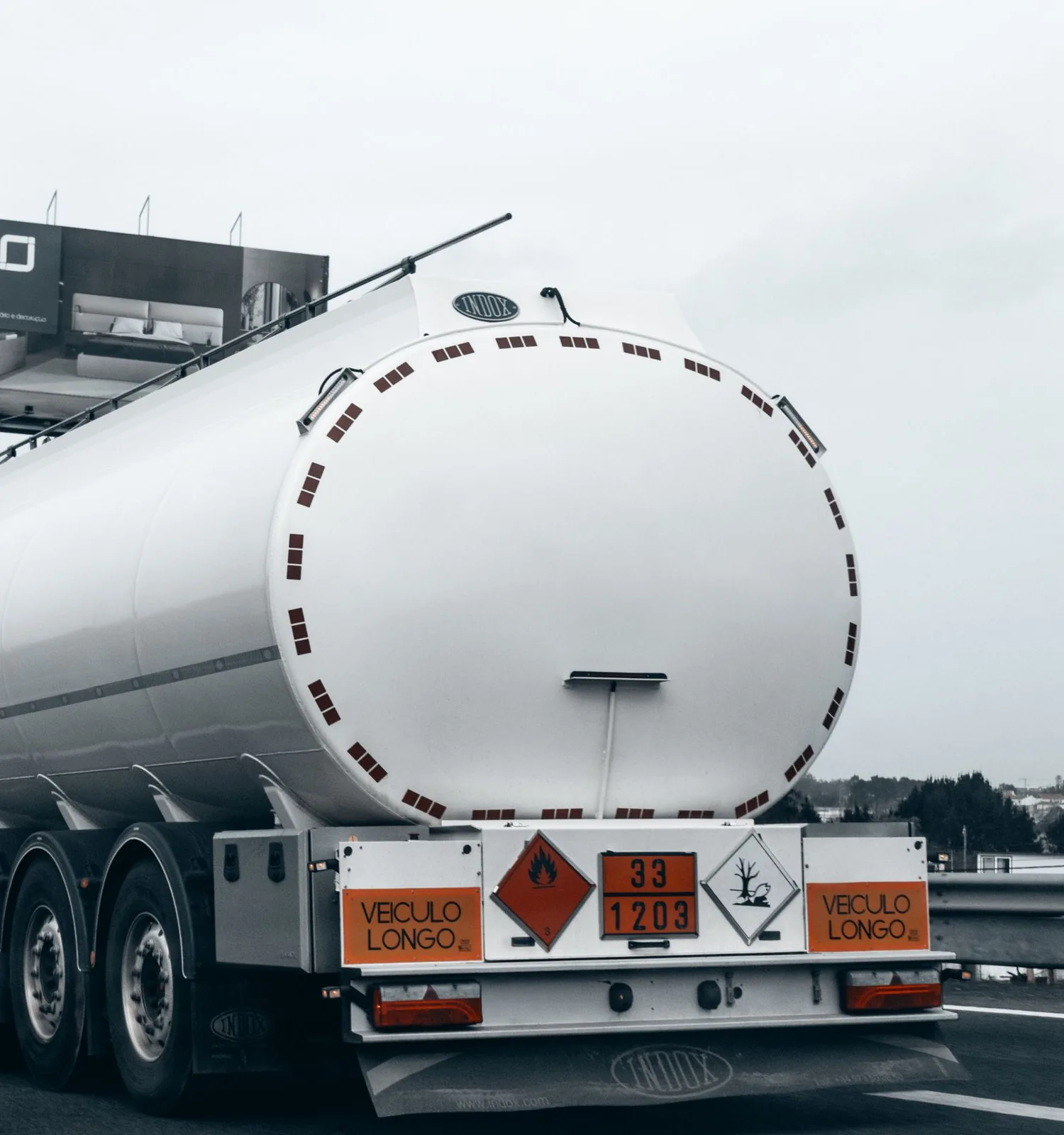 Tanker on the motorway with its orange ADR plate and hazard labels in view