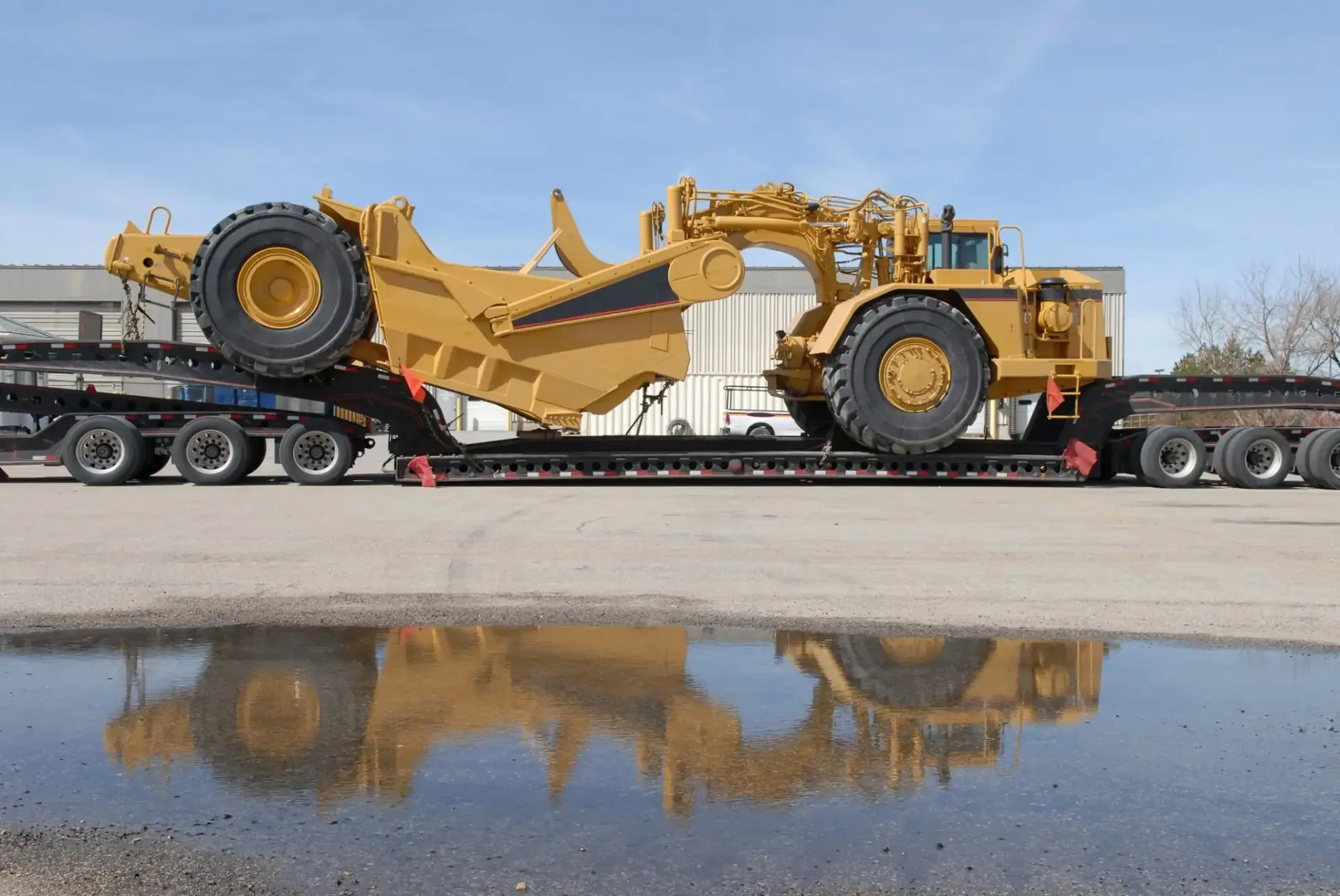 Mining scraper loaded on a low-bed semi-trailer, ready to be moved