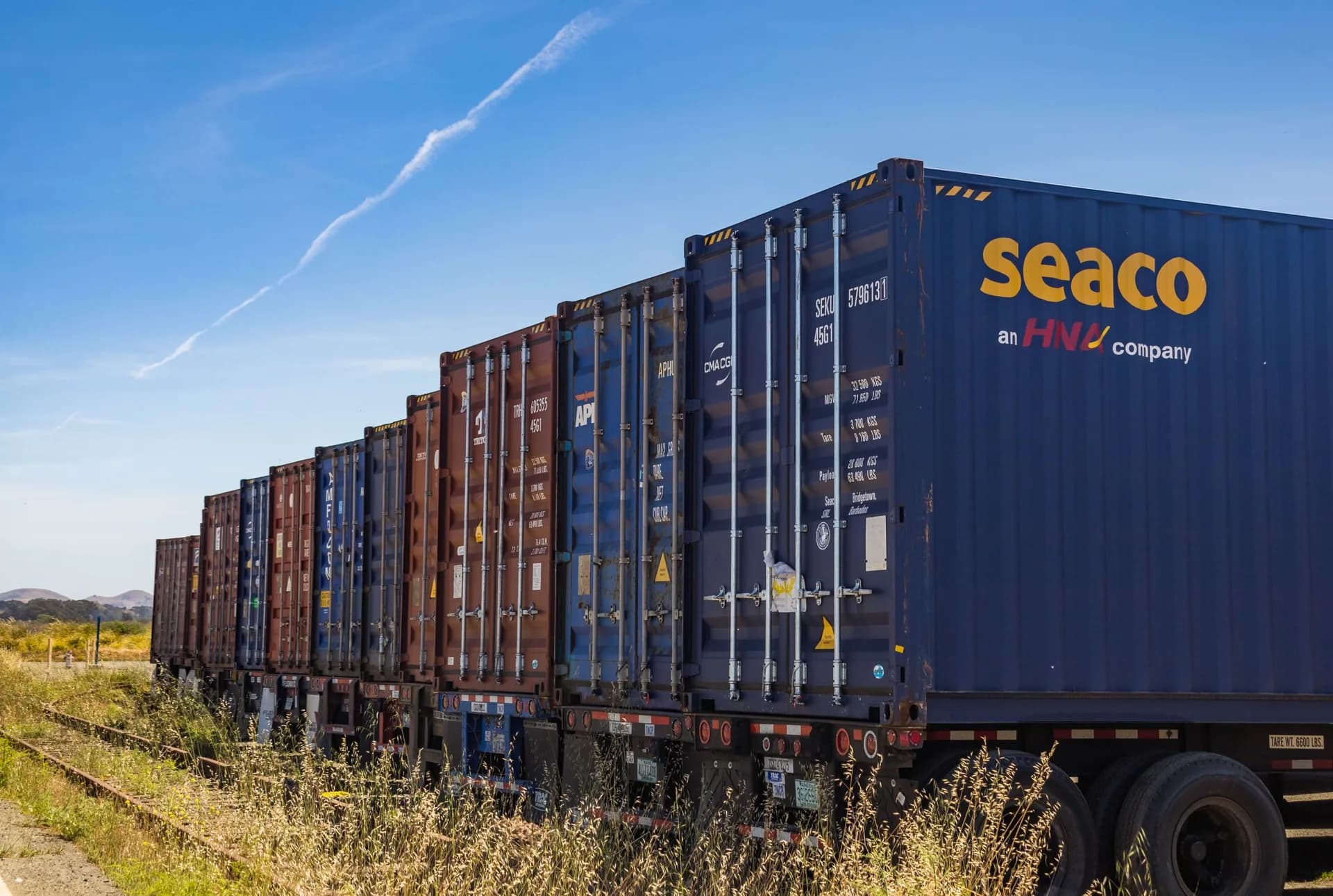 Freight train loaded with containers on the railway